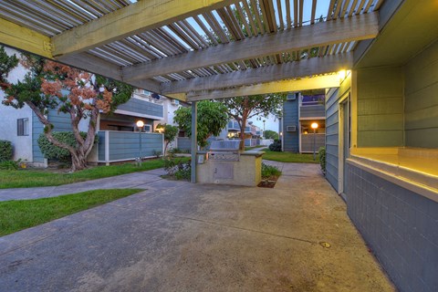 a covered patio with a fire pit and a porch