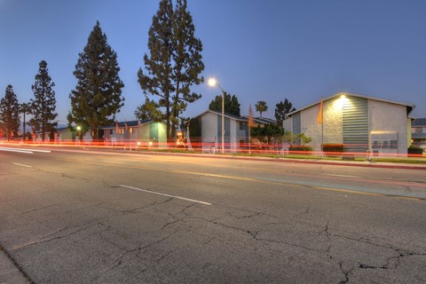 a city street at night with buildings and a street light