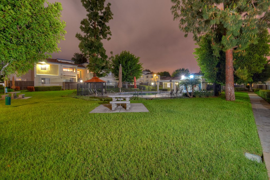 a park with a picnic table in the grass