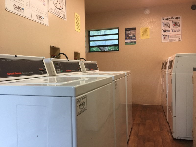 a laundry room with washers and machines in it
