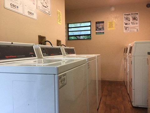 a laundry room with washers and machines in it