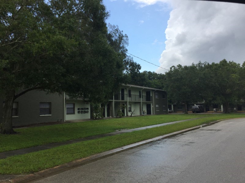 an empty street in front of an apartment building