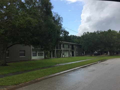 an empty street in front of an apartment building