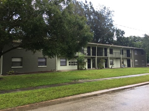 an apartment building with a lawn in front of it
