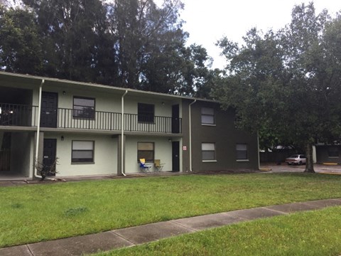 an apartment building with a lawn in front of it