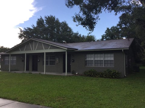 a house with a lawn and a tree