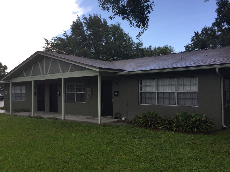 a house with a porch and a grass yard