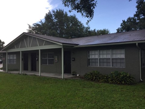 a house with a porch and a grass yard