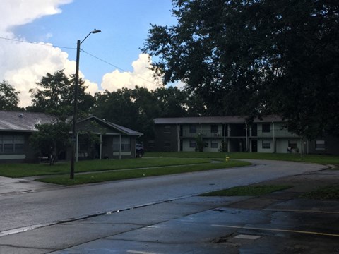 an empty street in front of an apartment building
