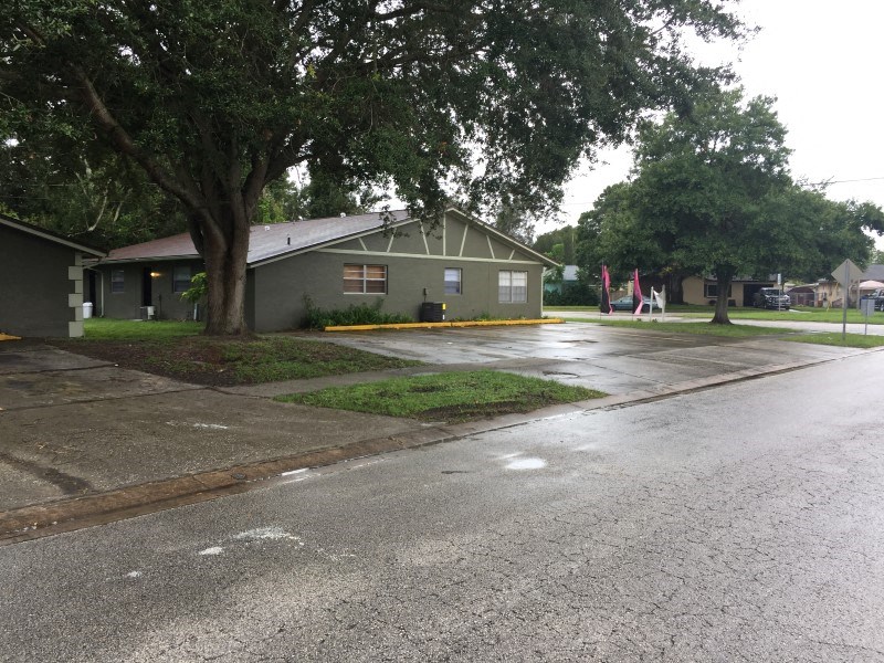 a house on the corner of a wet street
