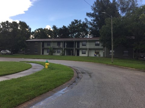 an apartment building with a yellow fire hydrant in front of it