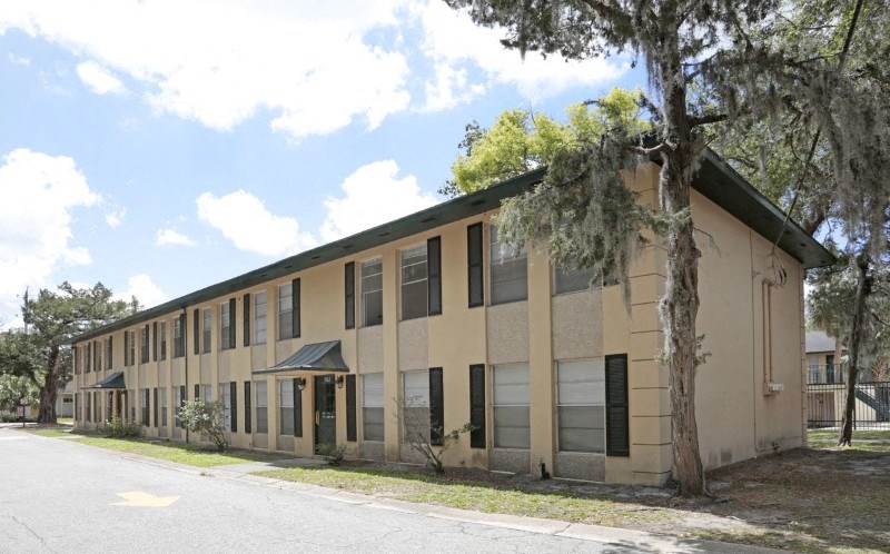 an office building with a tree in front of it