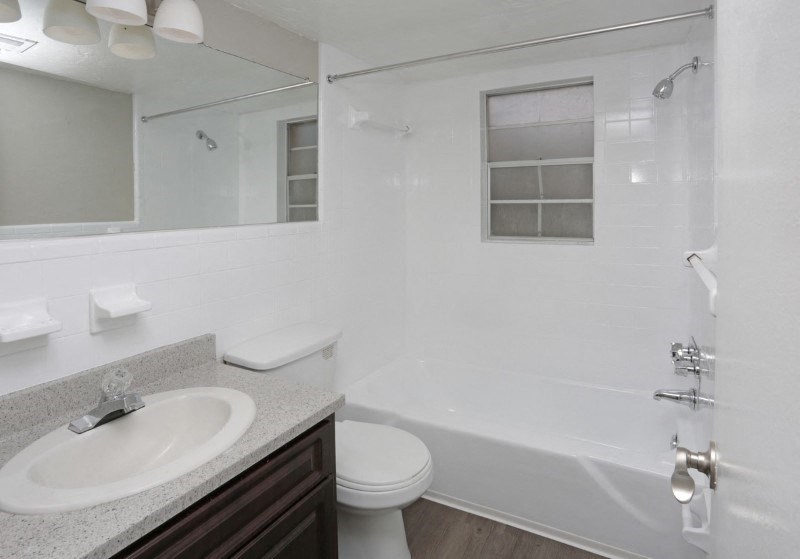 a bathroom with a sink toilet and a tub