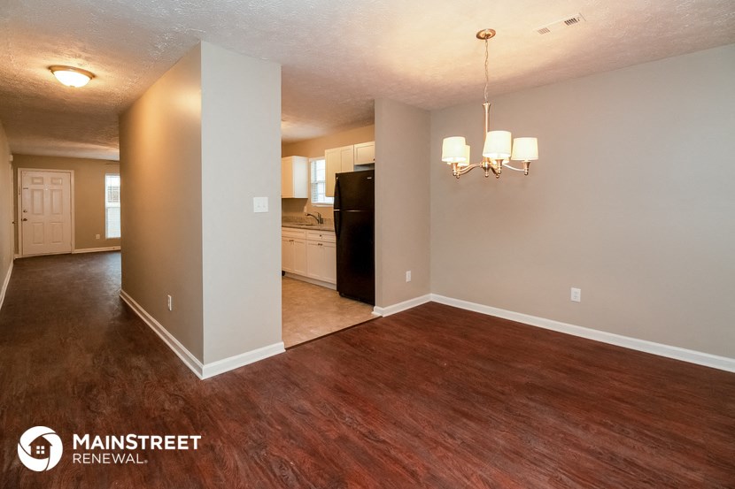 the living room and dining room of an open floor plan