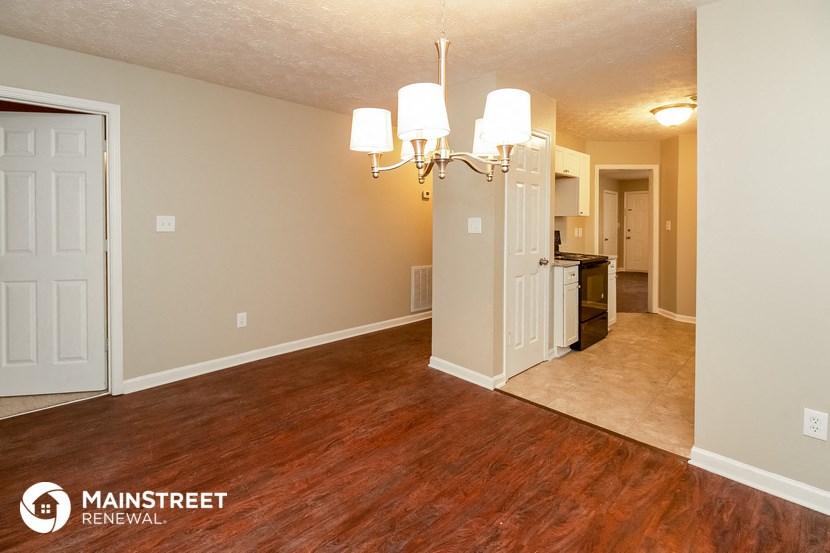 the living room and dining room of an apartment