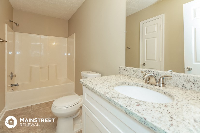 a bathroom with a sink and a toilet and a shower