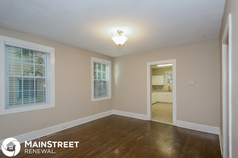 the living room and dining room of a renovated home