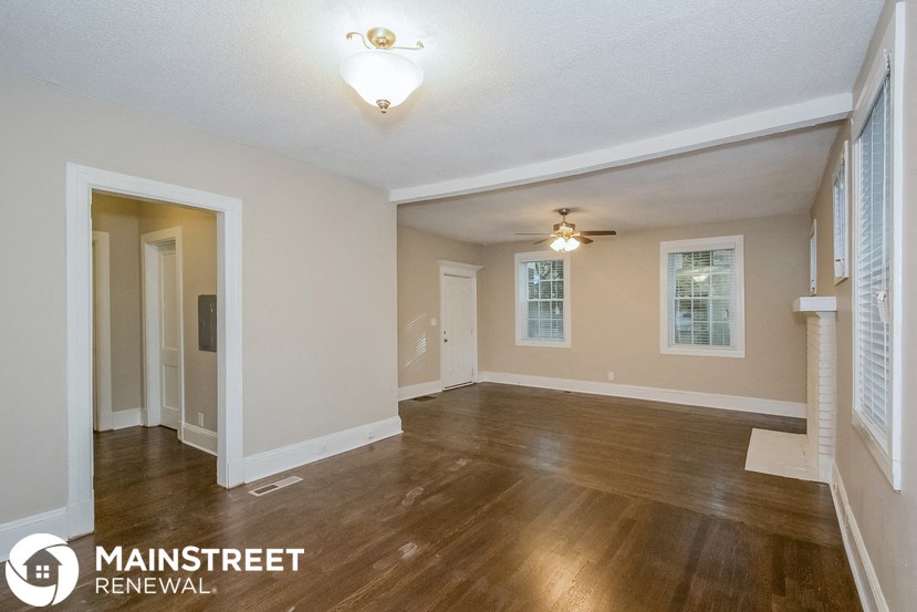 the living room and dining room of a renovated home