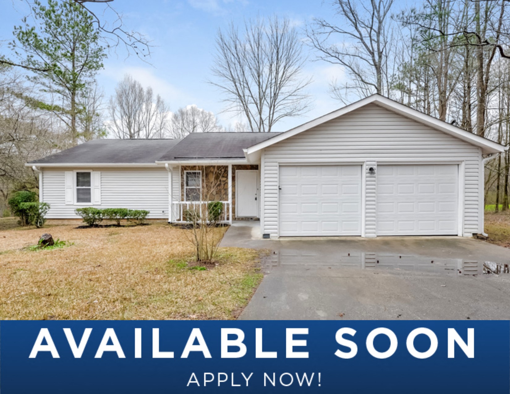 a small white house with a yard and a car garage