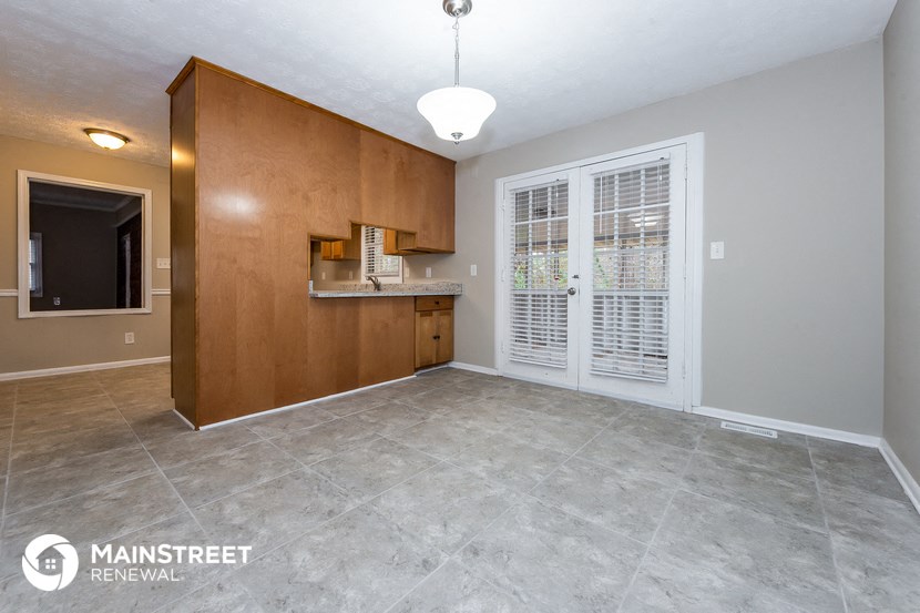 the living room and kitchen of an empty house