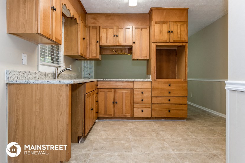 a kitchen with wooden cabinets and a counter top