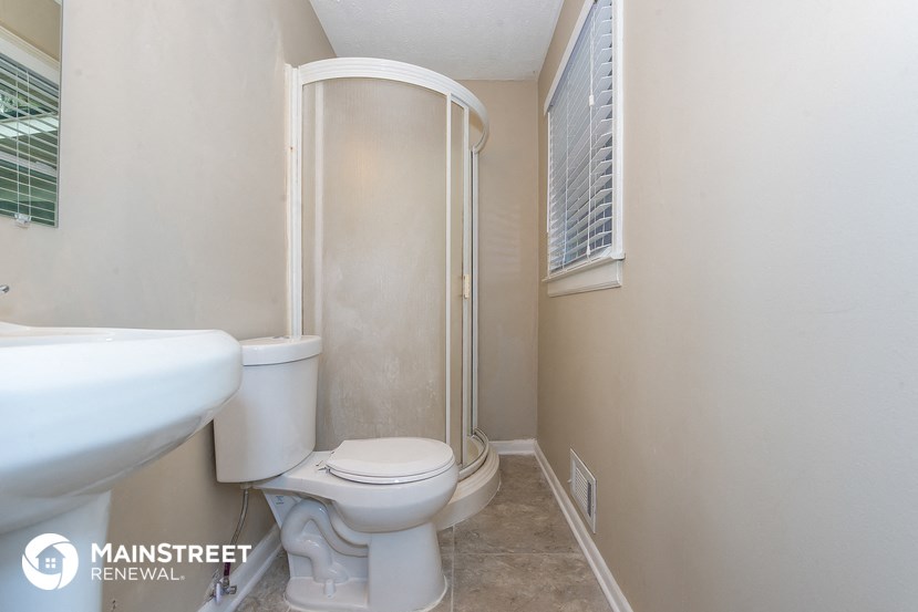 a small bathroom with a toilet and a shower