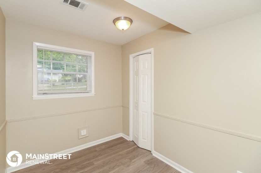 the upstairs bedroom has a door to the hallway and a window