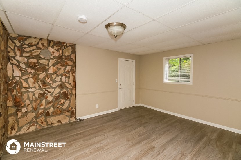 the interior of an empty room with wood floors and a white door