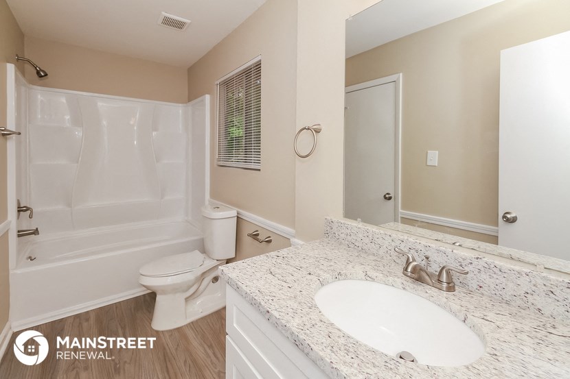 a bathroom with a sink and a toilet and a shower