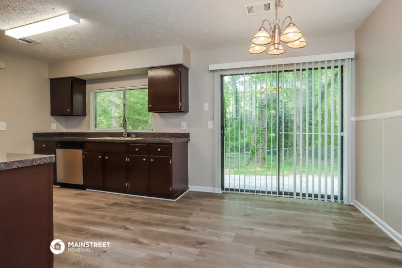 an empty kitchen with a sliding glass door to the yard