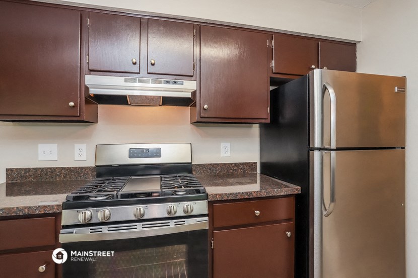 a kitchen with stainless steel appliances and brown cabinets
