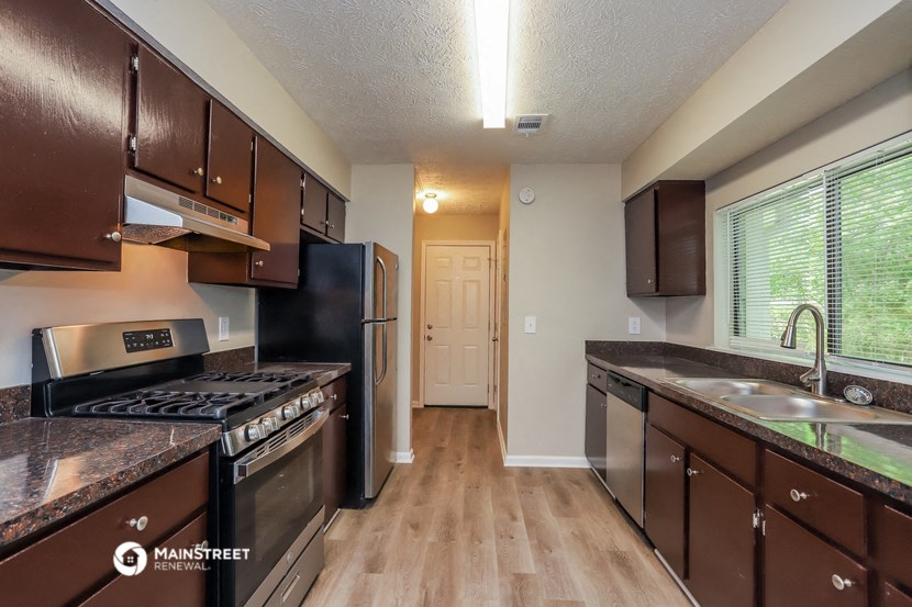 a kitchen with stainless steel appliances and wooden cabinets