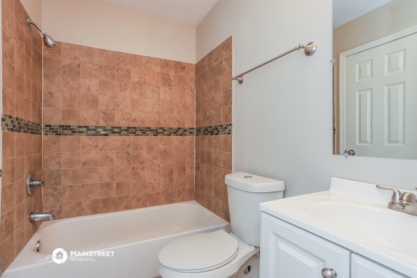 a bathroom with a sink toilet and a bath tub