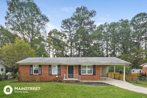 a small brick house with a covered porch and a