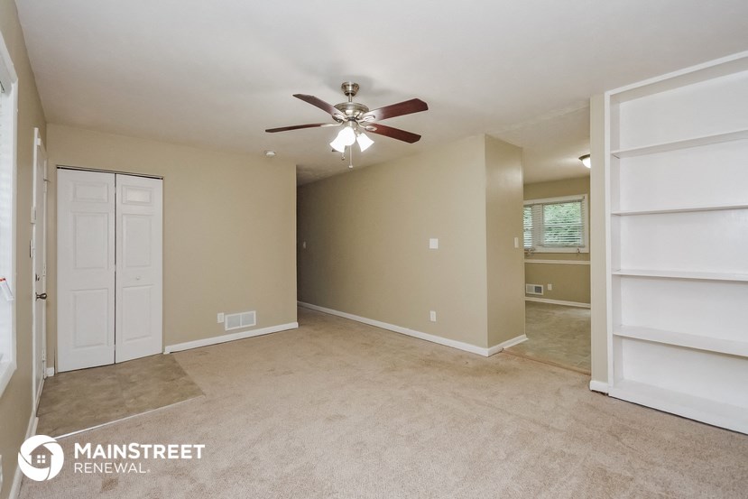 the master bedroom has a large closet and a ceiling fan