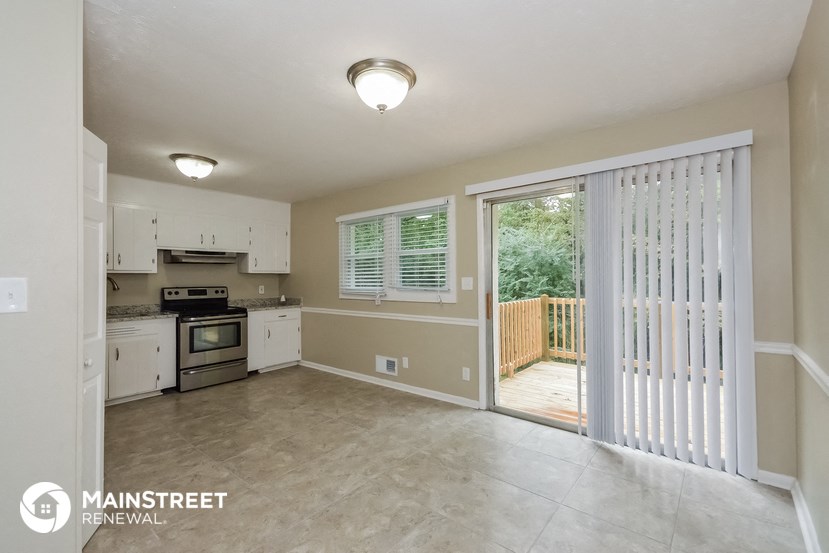 a kitchen with a sliding glass door leading to a deck
