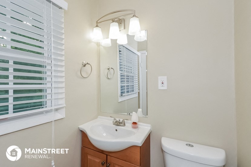 a bathroom with a sink and a mirror and a toilet
