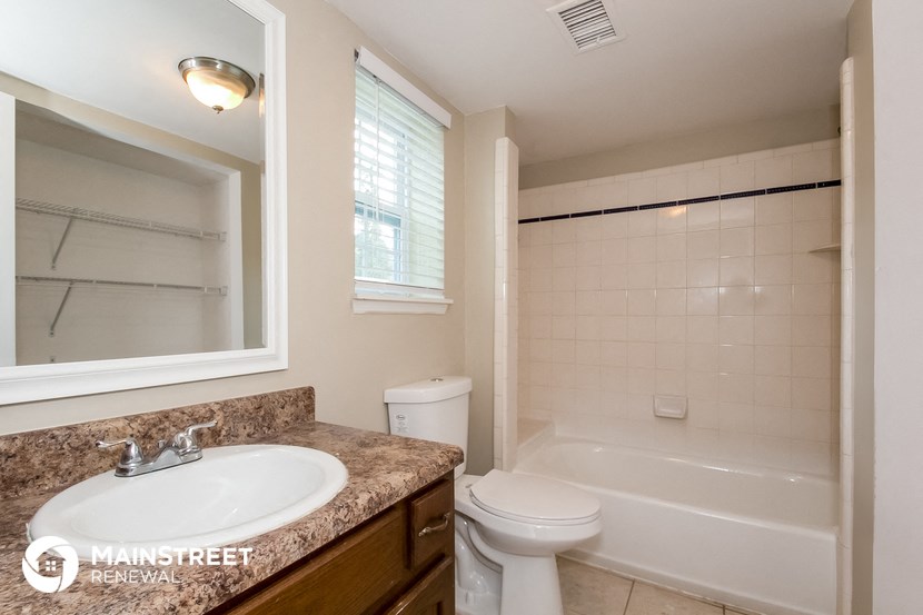 a bathroom with a sink and a toilet and a tub