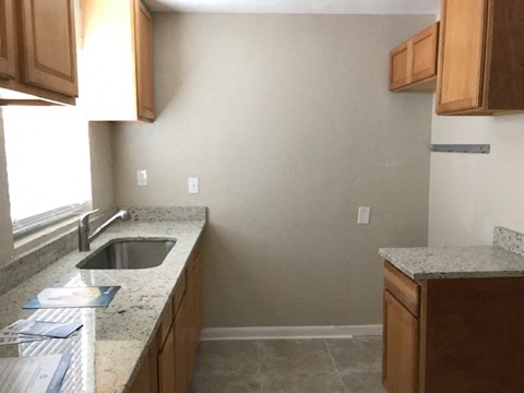 a kitchen with granite counter tops and a sink