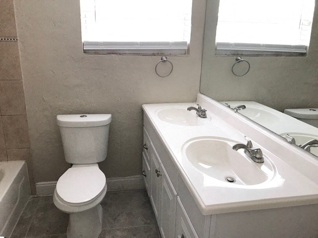 a bathroom with a toilet and a sink and a mirror