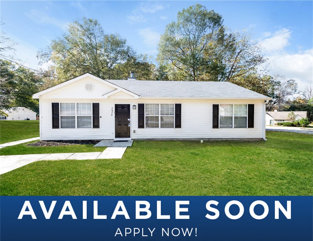 a white house with a green yard and a lawn