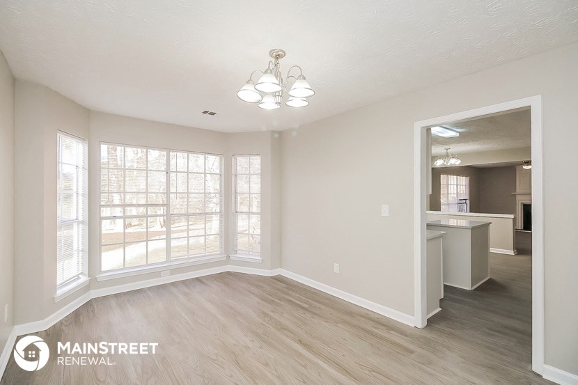 the living room and dining room of an apartment