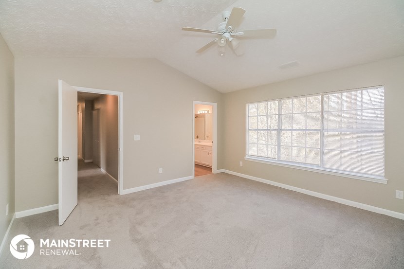 the master bedroom is spacious and has a ceiling fan