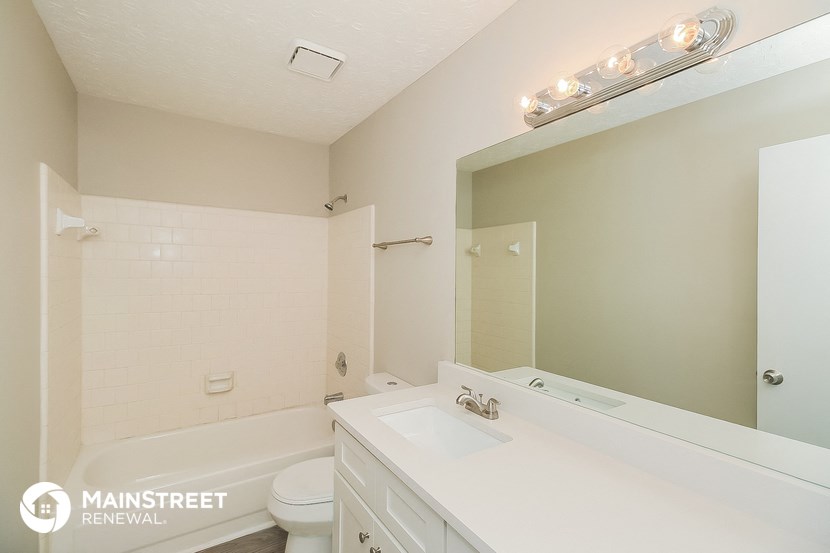 a bathroom with a sink and a toilet and a mirror