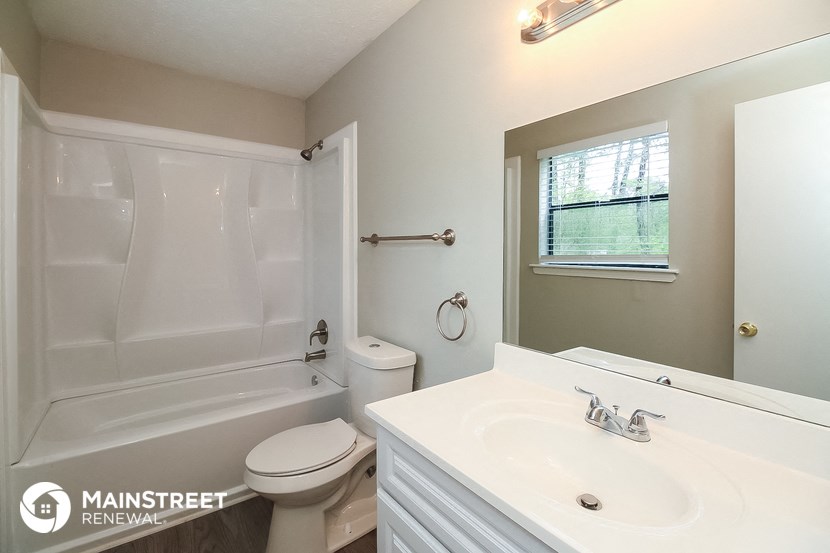 a bathroom with a sink and a toilet and a tub