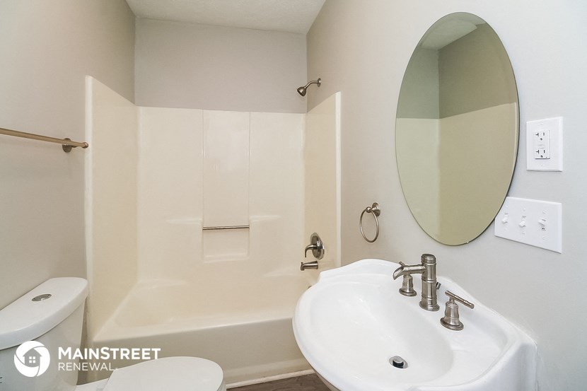 a bathroom with a sink and a mirror and a tub