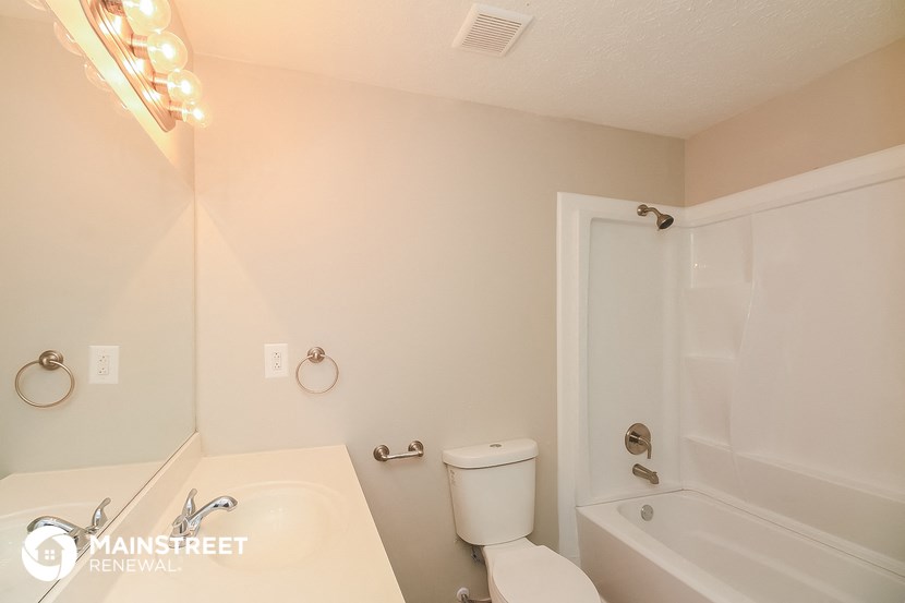 a bathroom with a sink toilet and shower and a bath tub