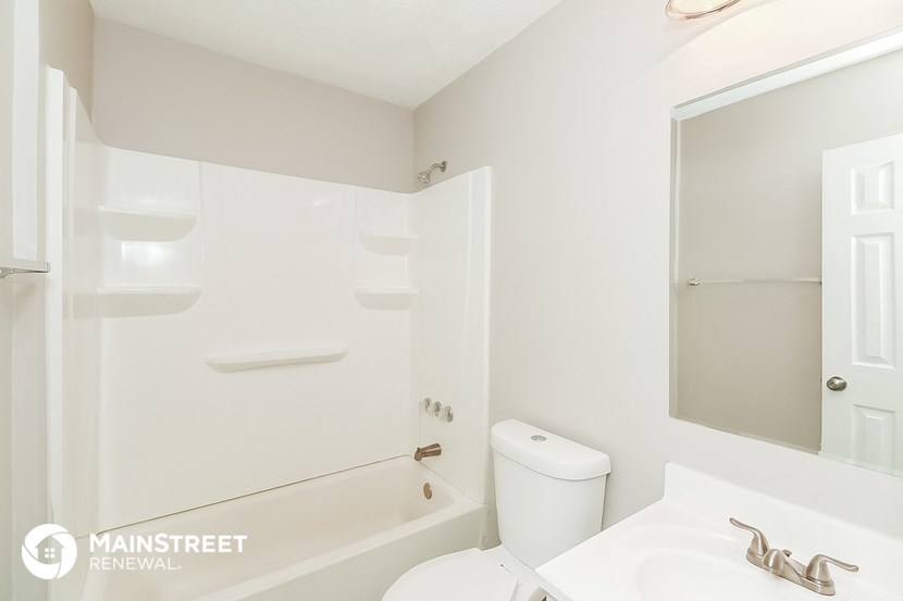 a bathroom with a sink and a toilet and a bath tub