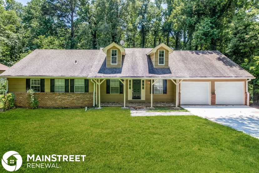 a home with a lawn and a garage