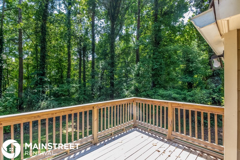 a view of the woods from the deck of a house